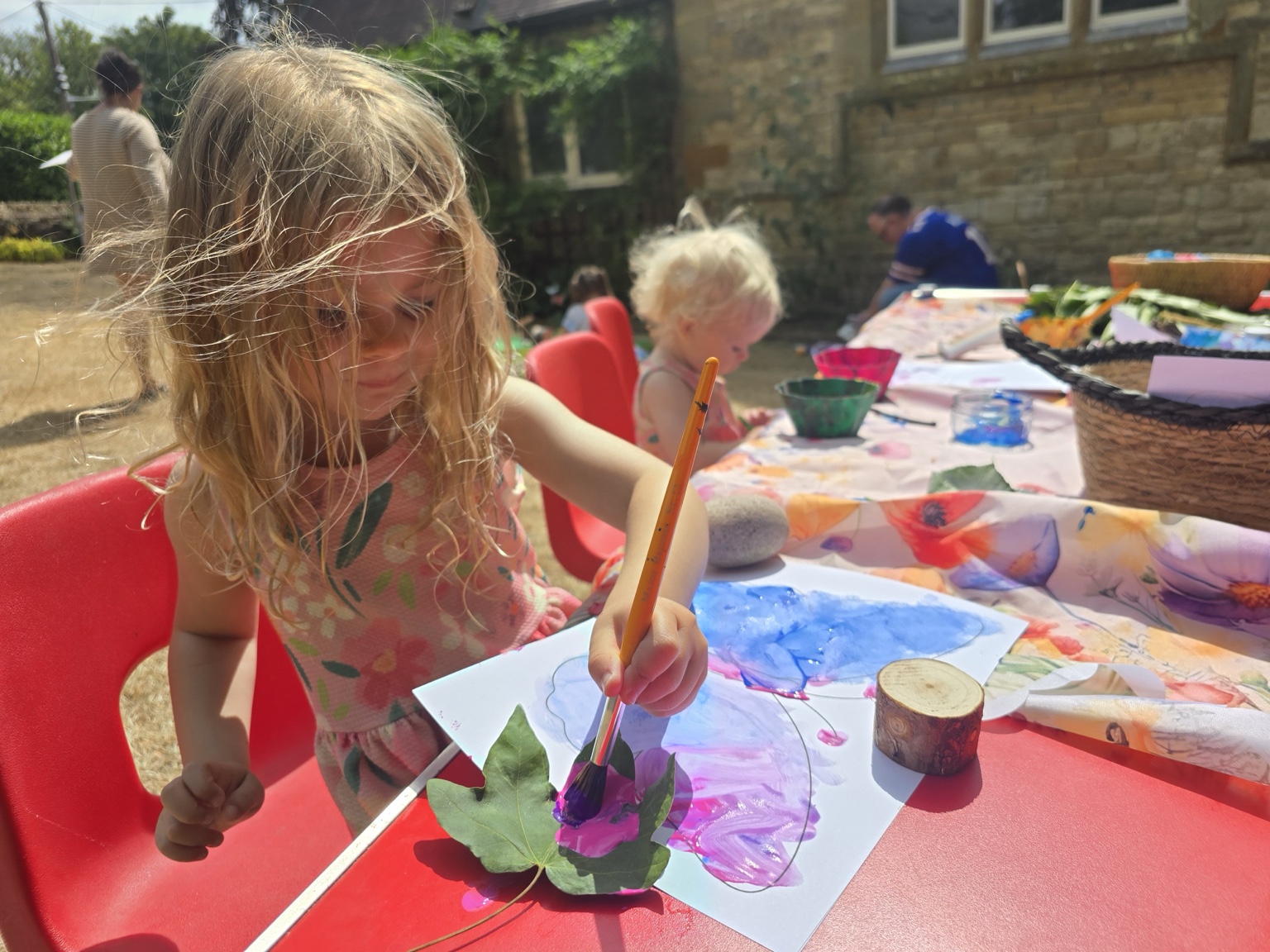A child painting a colourful butterfly at the Maker’s Table